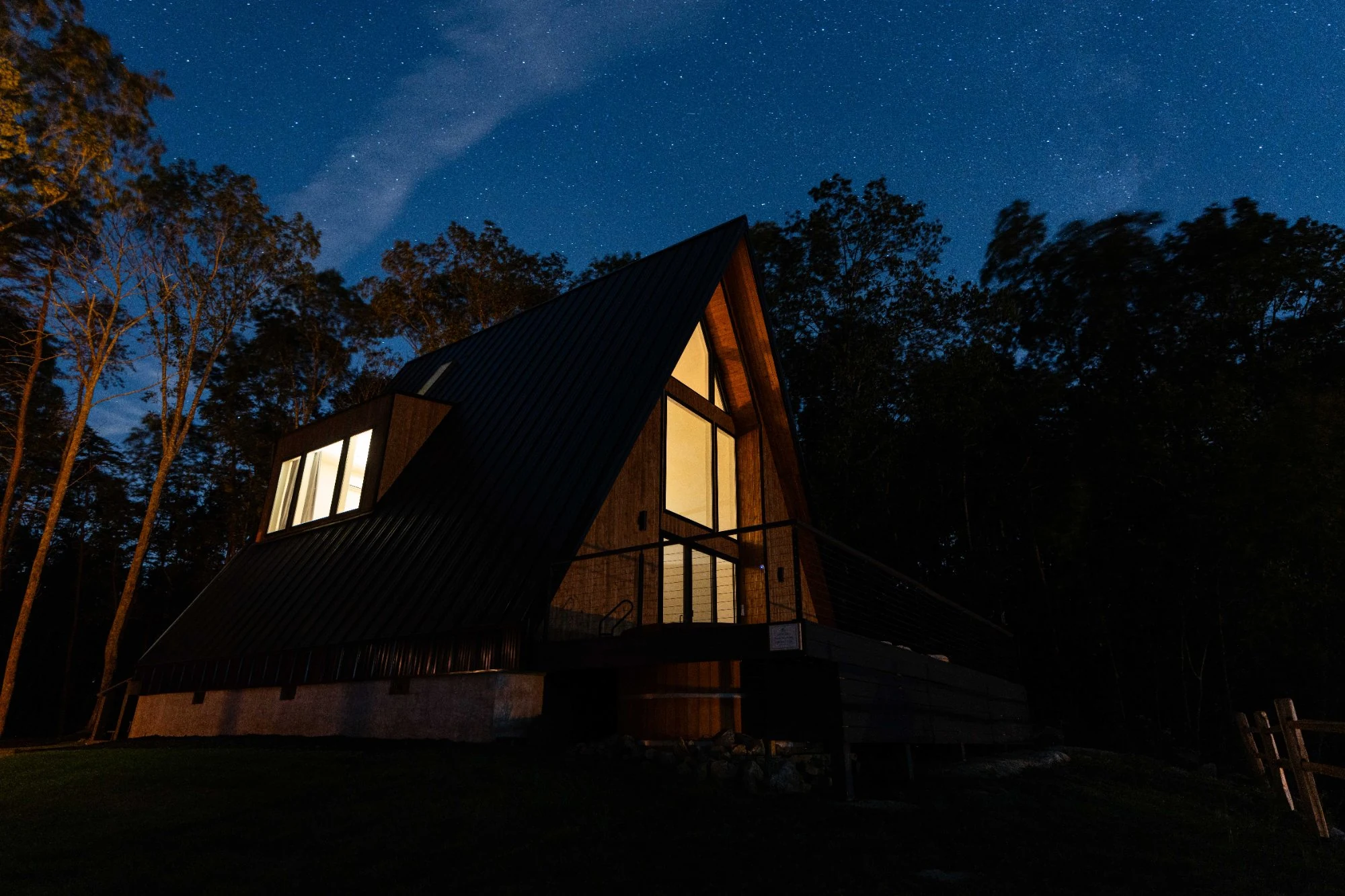 Luxury A-Frame cabin under a star-filled dark sky on the Cumberland Plateau in Dunlap, Tennessee