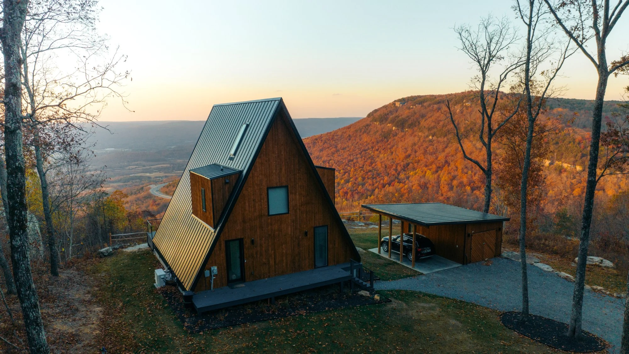 Modern A-Frame cabin exterior with fall sunset colors overlooking the Sequatchie Valley on the Cumberland Plateau
