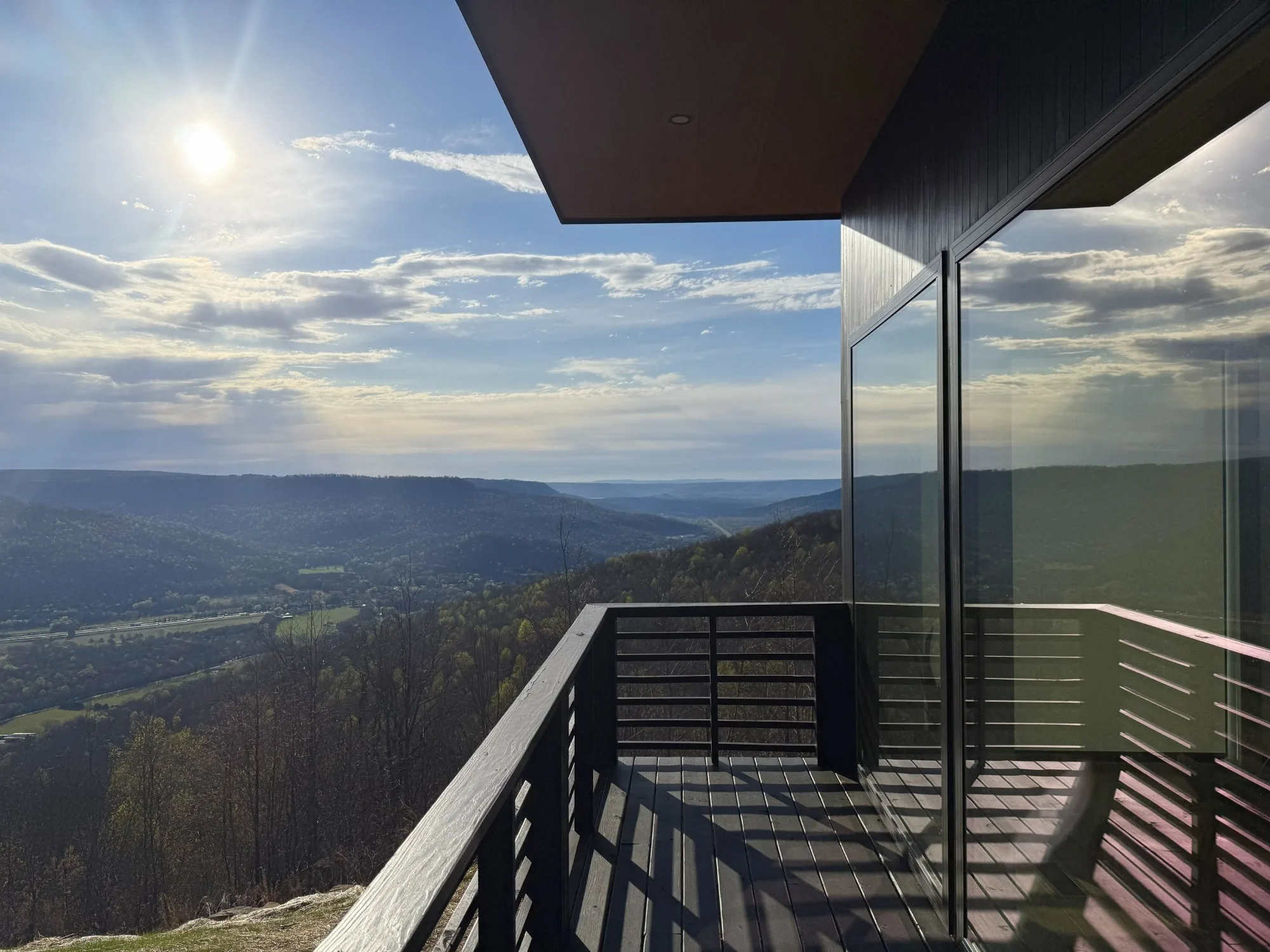 Cantilevered wooden deck with a sunrise panorama of the Tennessee valley at Jackson Point, Sewanee